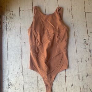 Nulux lululemon bodysuit, never worn. Built in bra !